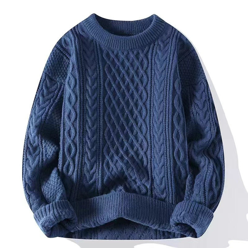 Cable knit crewneck pullover laid flat, textured braided panels across the chest front