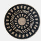 Natural straw woven wall ornament resting against a light neutral background