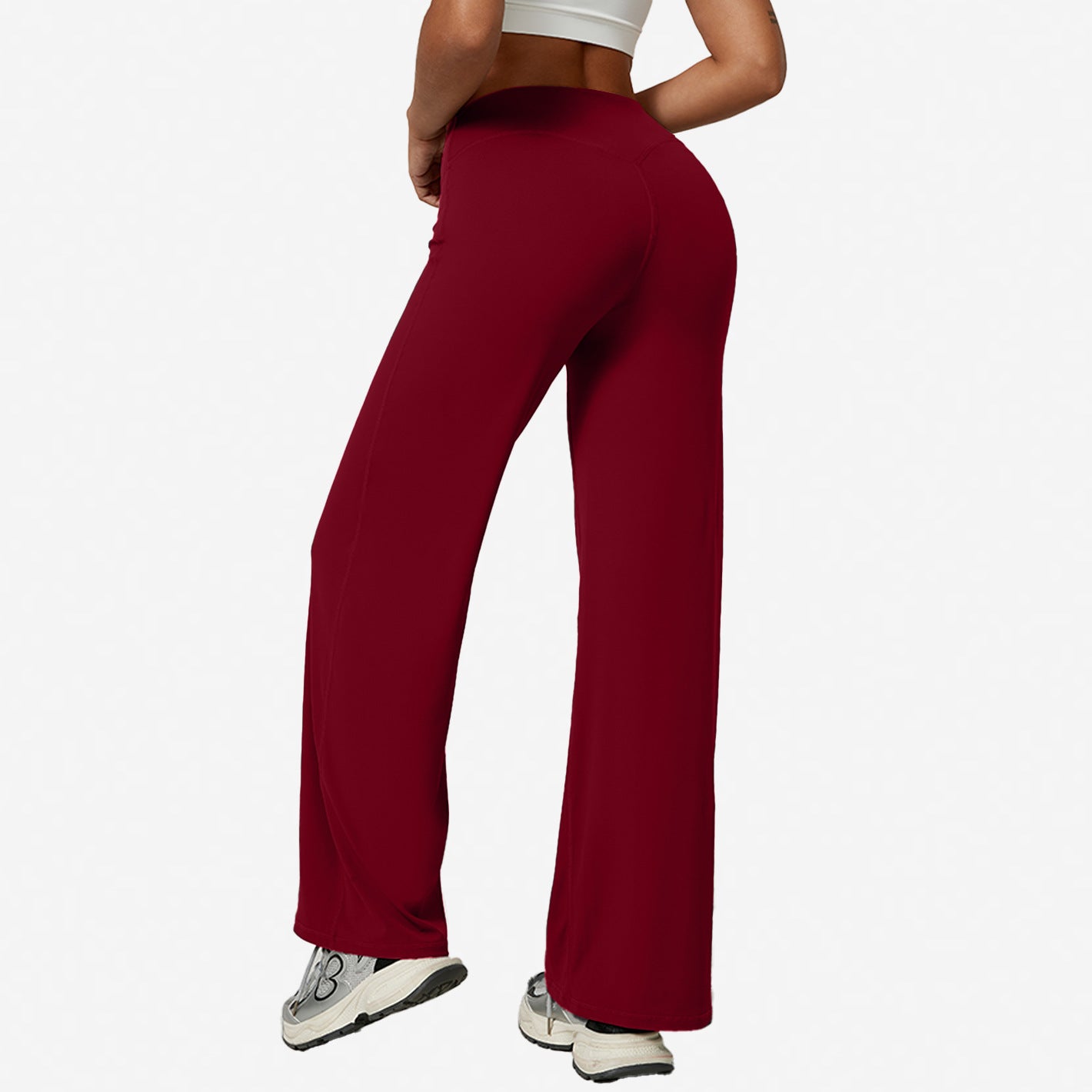 Wine red high-waist wide-leg flared yoga pants rear view on a model against a white backdrop
