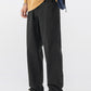 Black straight leg cotton pants worn with a mustard sweater and colorful low sneakers