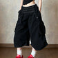 Black cotton wide leg cropped cargo pants with a double row buttoned waistband on a model