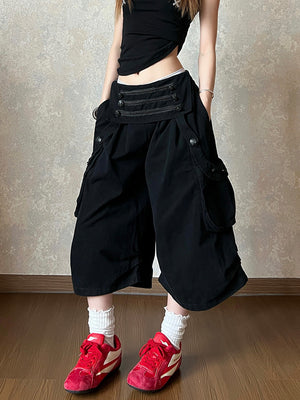 Black cotton wide leg cropped cargo pants with a double row buttoned waistband on a model