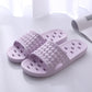 Bath slippers on a wet tile floor showing the non-slip textured tread