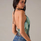 Green geometric print sleeveless blouse worn in a daily setting