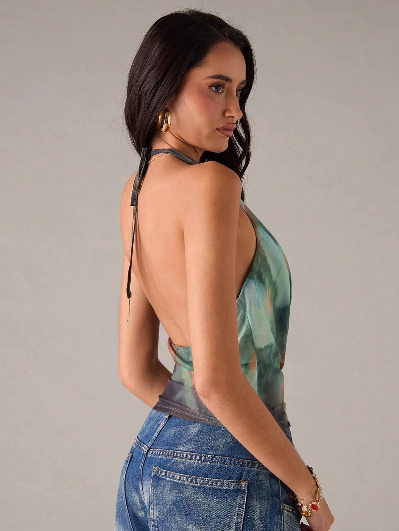 Green geometric print sleeveless blouse worn in a daily setting