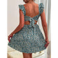 Close view of the ditsy floral print and ruffled shoulder straps on the mini dress