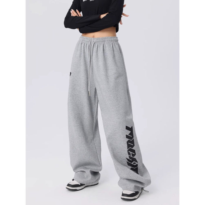 Grey wide leg dance pants shown to display the loose straight cut and long length