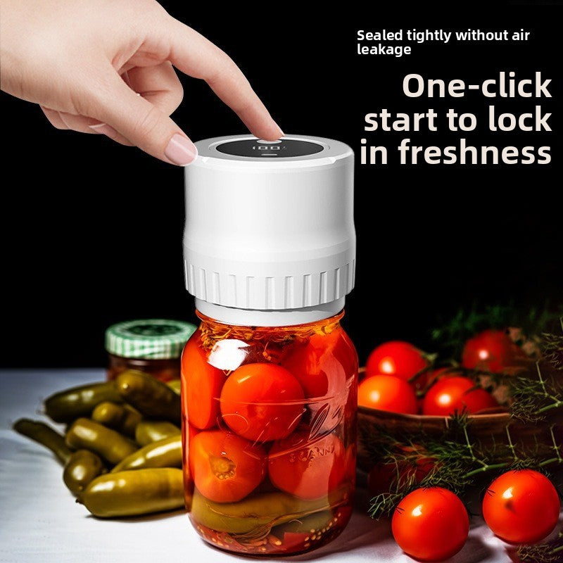 Black mason jar vacuum sealer with lids, a lid lifter tool and a USB charging cable laid out