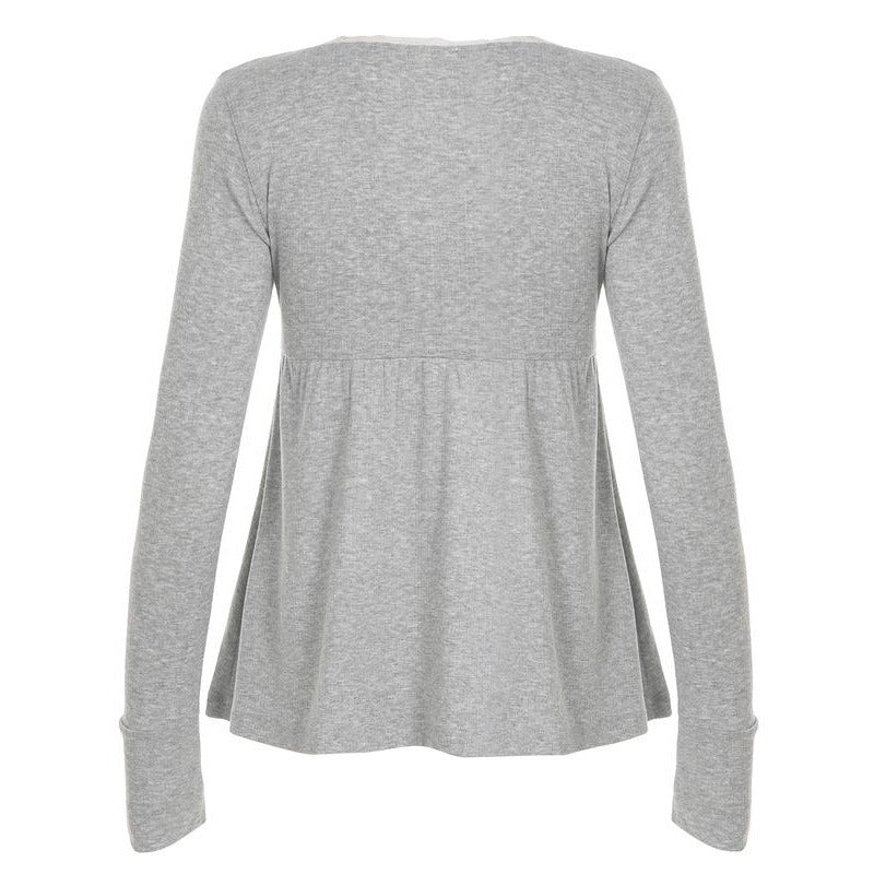 Back view of a gray long sleeve babydoll top with a gathered waist seam and deep cuffs on a plain background