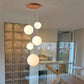 Adjustable cords holding the globes at staggered drops