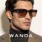 Square acetate sunglasses shown at an angle on a pale surface in warm light