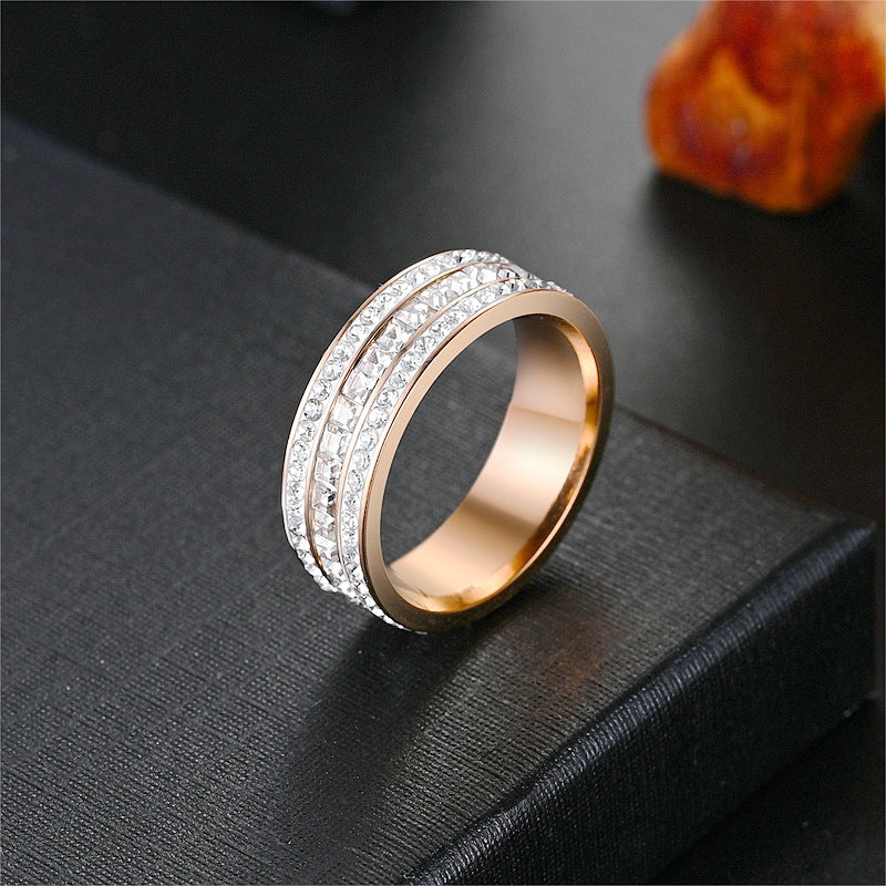 Rose gold tone three row cubic zirconia band ring on a black surface, size No. 12 option