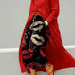 Wide leg cropped black denim jeans with cream and red lip print pattern, red coat and red heels