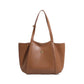 Faux leather shoulder tote carried over the shoulder in a daily setting