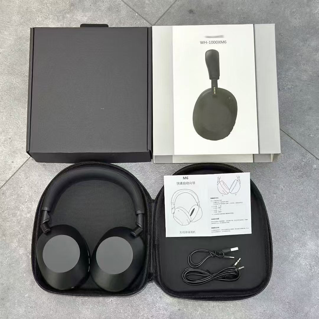 Black over-ear headphones in an open hard zip case beside a gift box, with USB-C and aux cables laid out