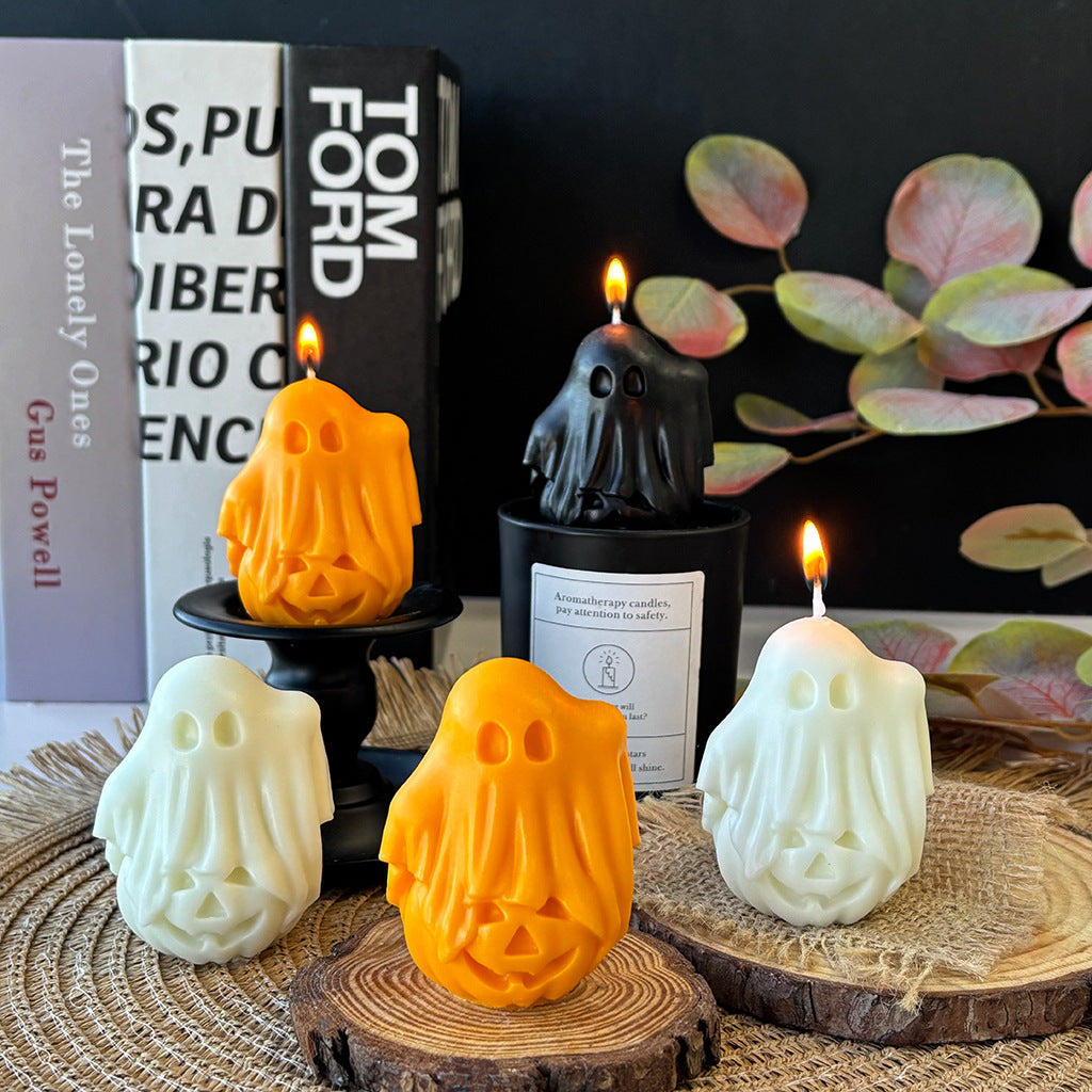 Group of handmade ghost candles arranged as a Halloween vignette