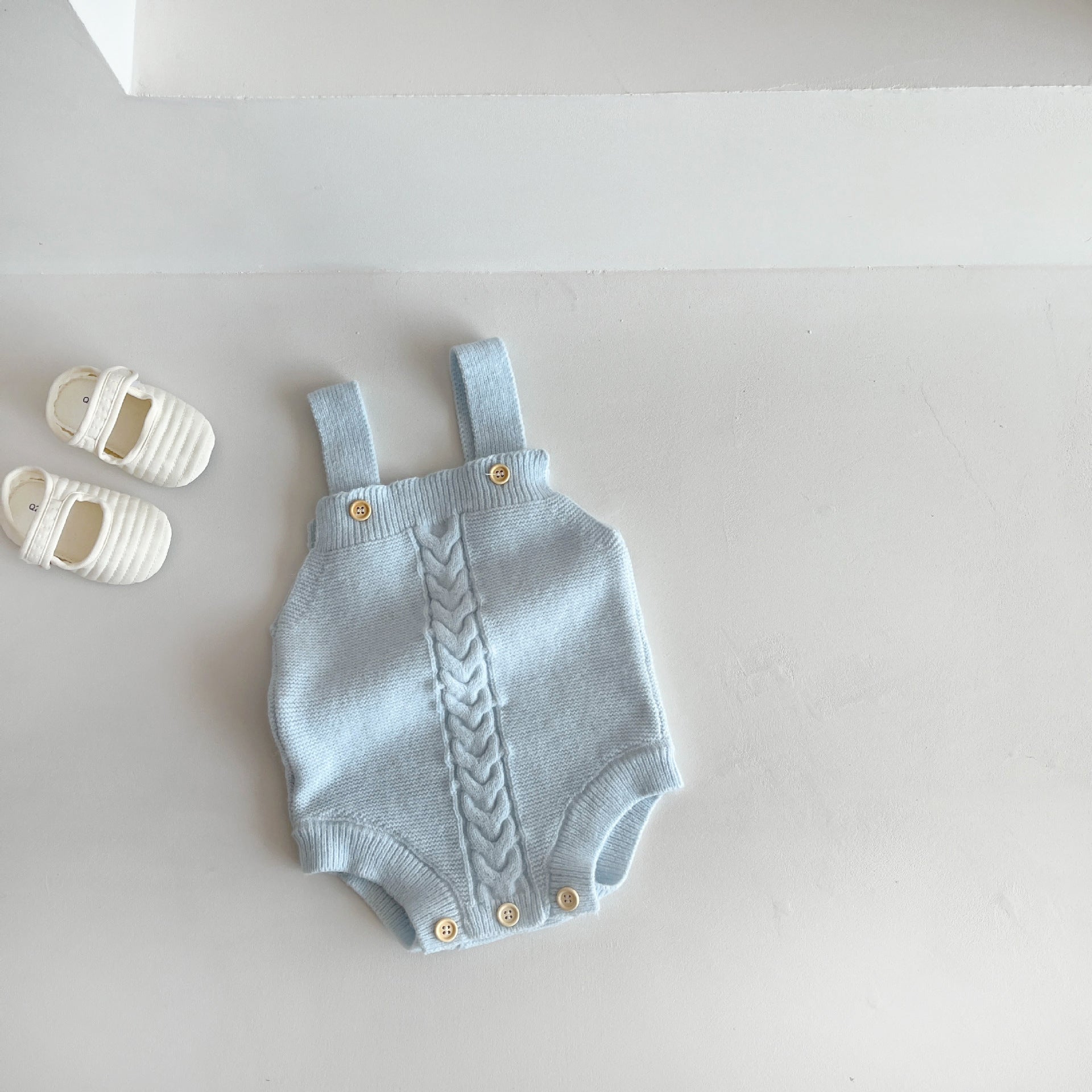 Baby knit cotton romper styled in a calm interior setting for babies