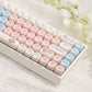 Cute mechanical keyboard with pink and blue rabbit themed keycaps on white body