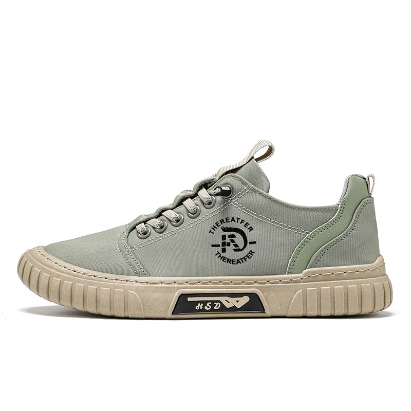 Green lace up canvas sneaker side view on white with a round printed emblem and a beige ribbed sole