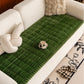 Sweet Serene Dark Green quilted plush sofa cover on a sofa, 90 x 210 cm