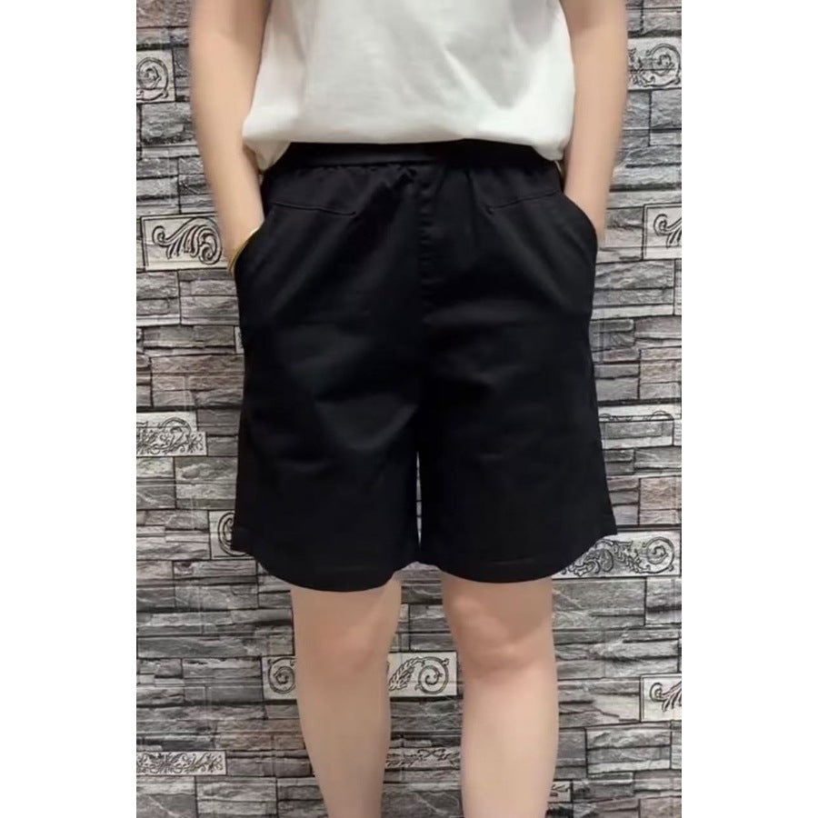 Black wide leg shorts front view with slant hip pockets and side tab