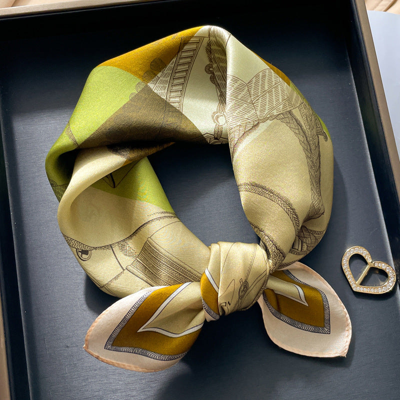 Yellow and olive geometric printed square scarf with a satin sheen and hemmed edges, shown displayed