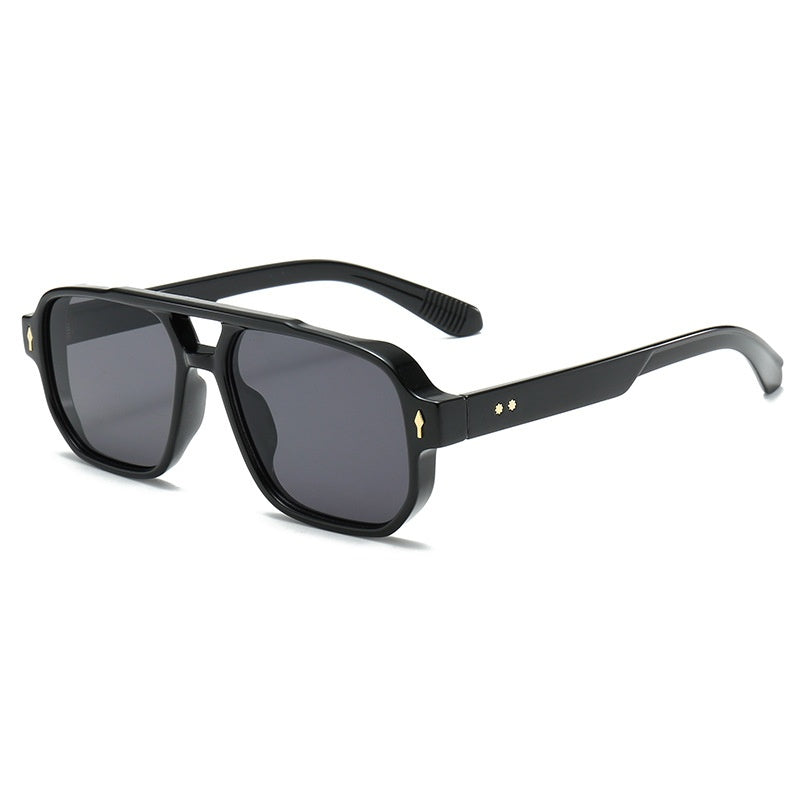 Square double bridge sunglasses with a black frame and smoke gray lenses, angled view