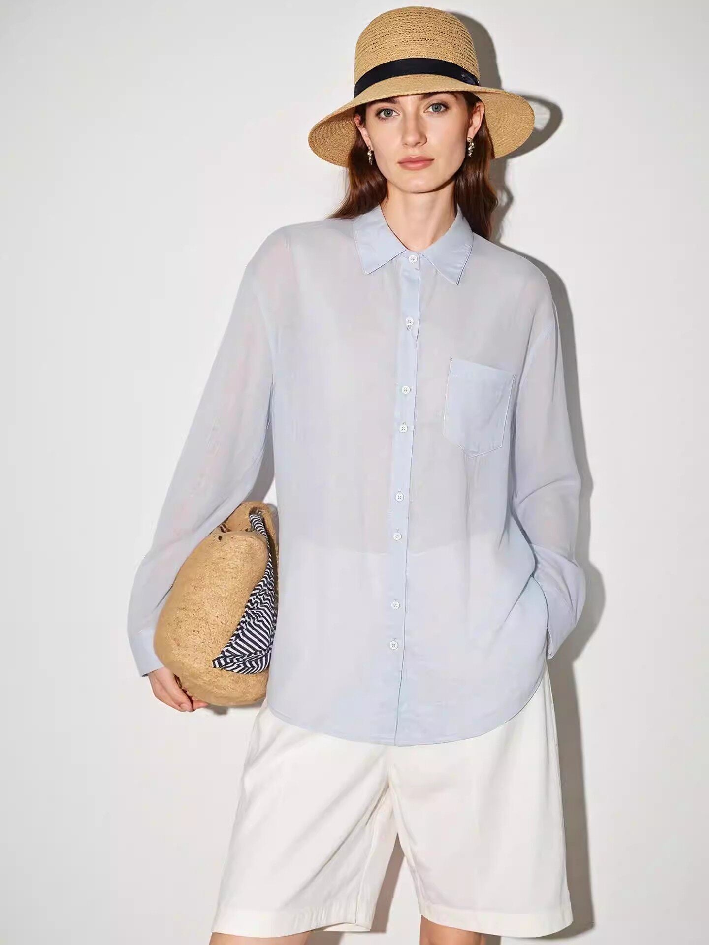 Close view of the lapel collar and single patch chest pocket on a linen button-up shirt