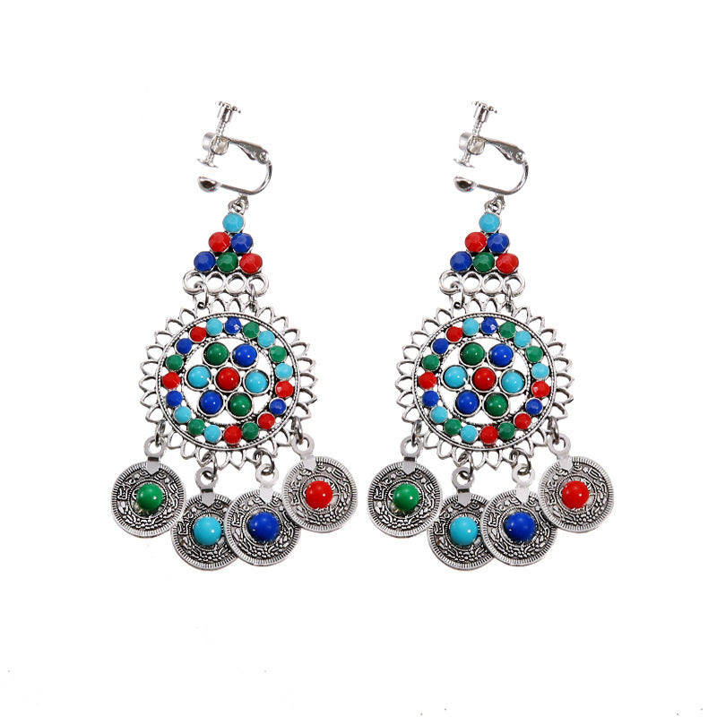 Handmade bohemian clip-on earrings with tassel and bead drop detail, zinc alloy frame, studio shot on white background
