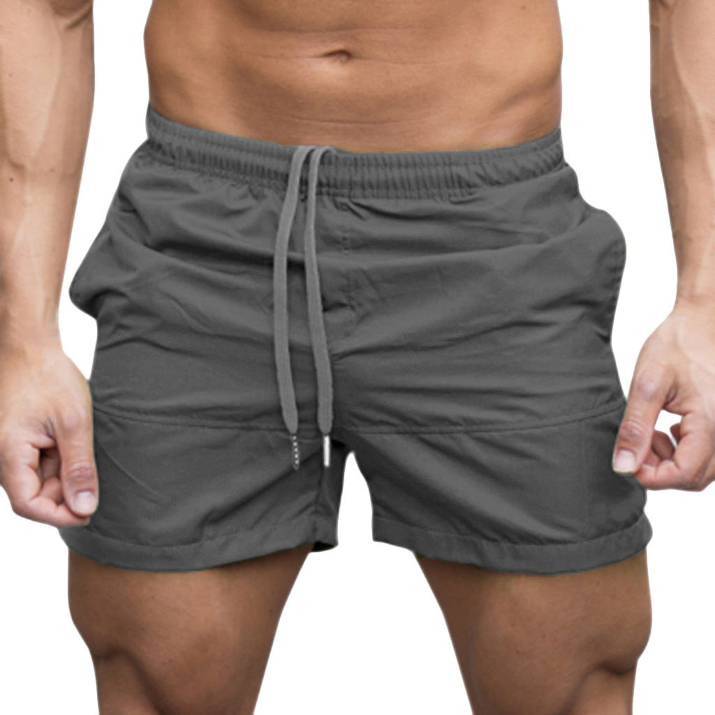 Dark blue men's beach shorts with tie drawstring on model front view