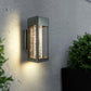 Pair of LED crystal wall sconces lighting an exterior facade at dusk