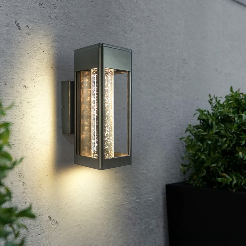 Pair of LED crystal wall sconces lighting an exterior facade at dusk