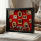 Black shadow box with a red backdrop, gold miniature photo frames, a butterfly and figurines on a marble shelf