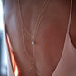 Close up of the teardrop imitation pearl on the gold back chain