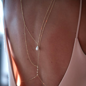 Close up of the teardrop imitation pearl on the gold back chain