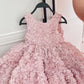 Child wearing the pink rosette princess party dress at a birthday celebration