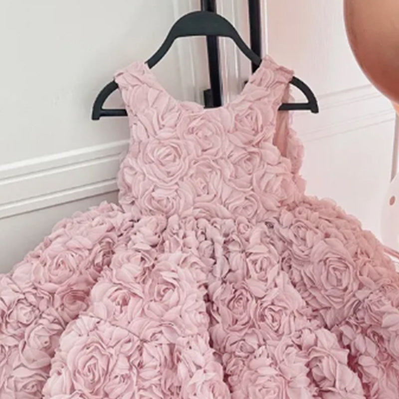 Child wearing the pink rosette princess party dress at a birthday celebration
