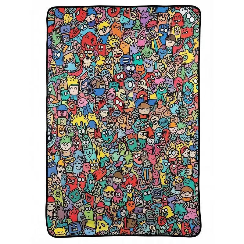 Close view of the dense doodle character art printed on the felt throw