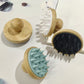 Pink bamboo and silicone scalp massage brush showing the rounded wooden knob handle on the back
