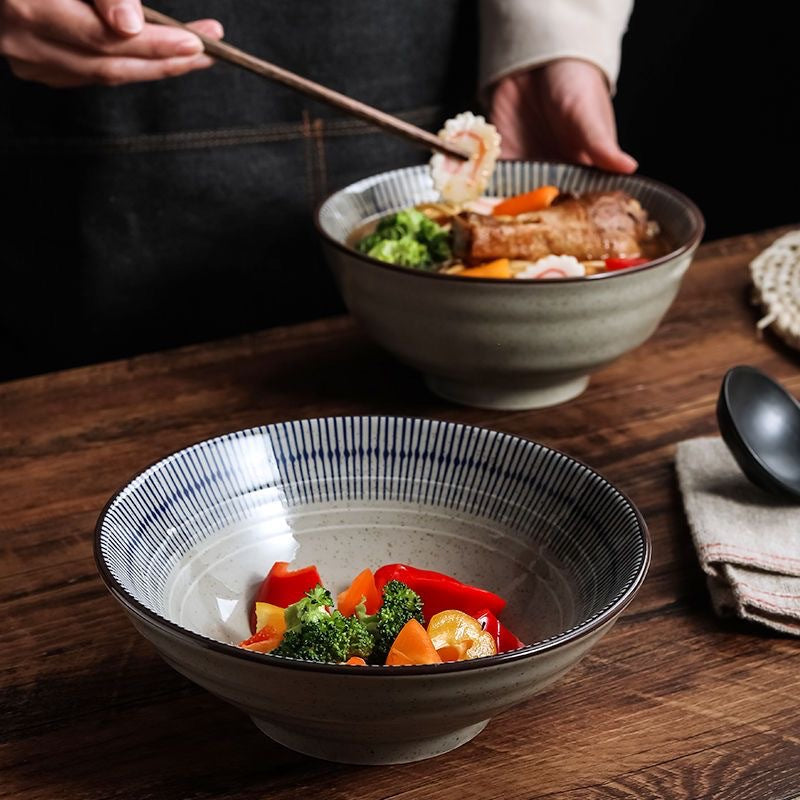 Side profile of the stoneware noodle bowl showing the tall wall and footed base