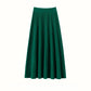 Emerald green ribbed A-line midi skirt with tiered seams and a wide waistband, flat view on white