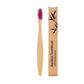 Pink bristle bamboo toothbrush shown against a soft background