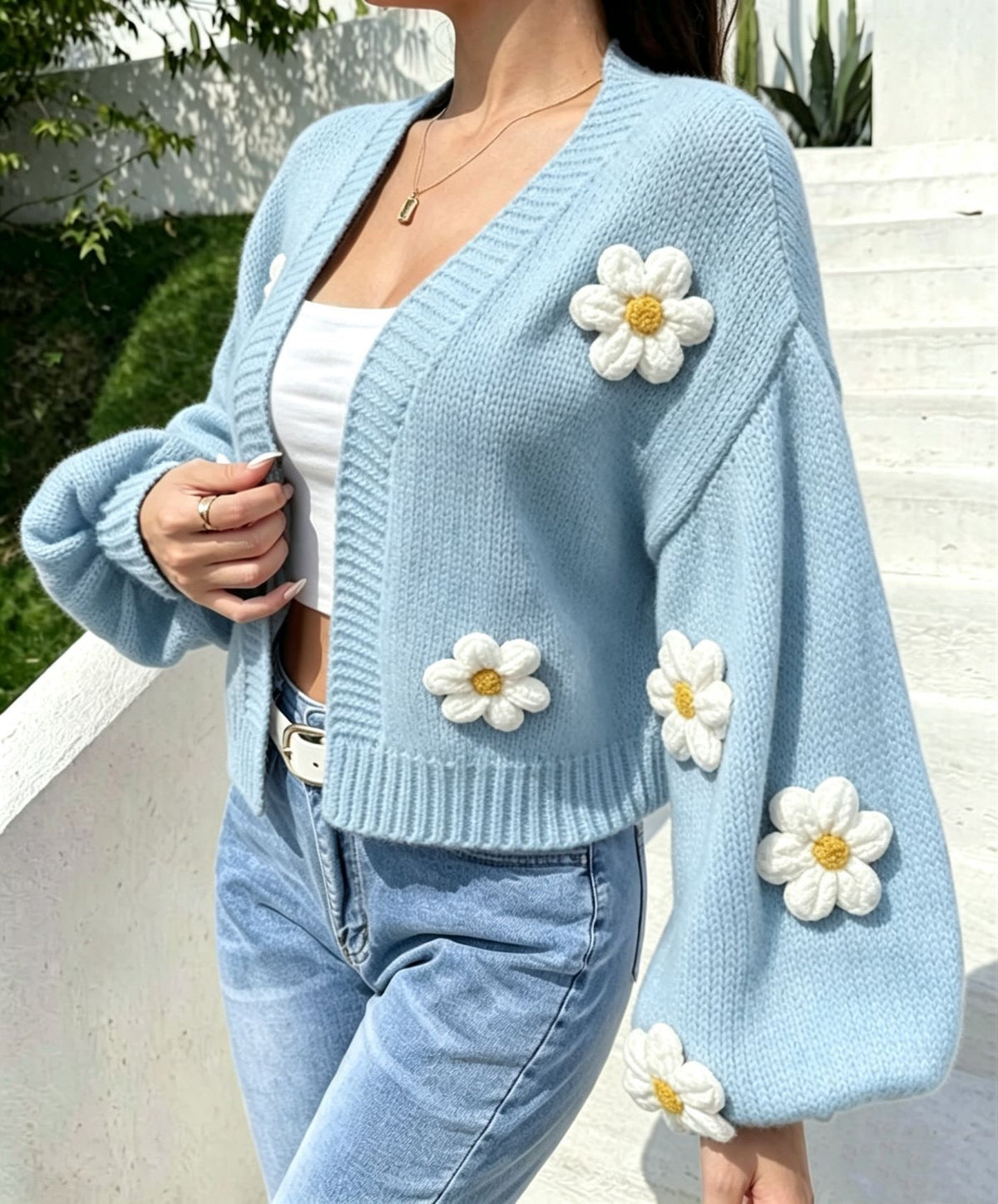 V neckline and ribbed front band of the floral open front knit cardigan