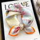 Cream multicolor floral printed square scarf with a satin sheen and hemmed edges, shown displayed