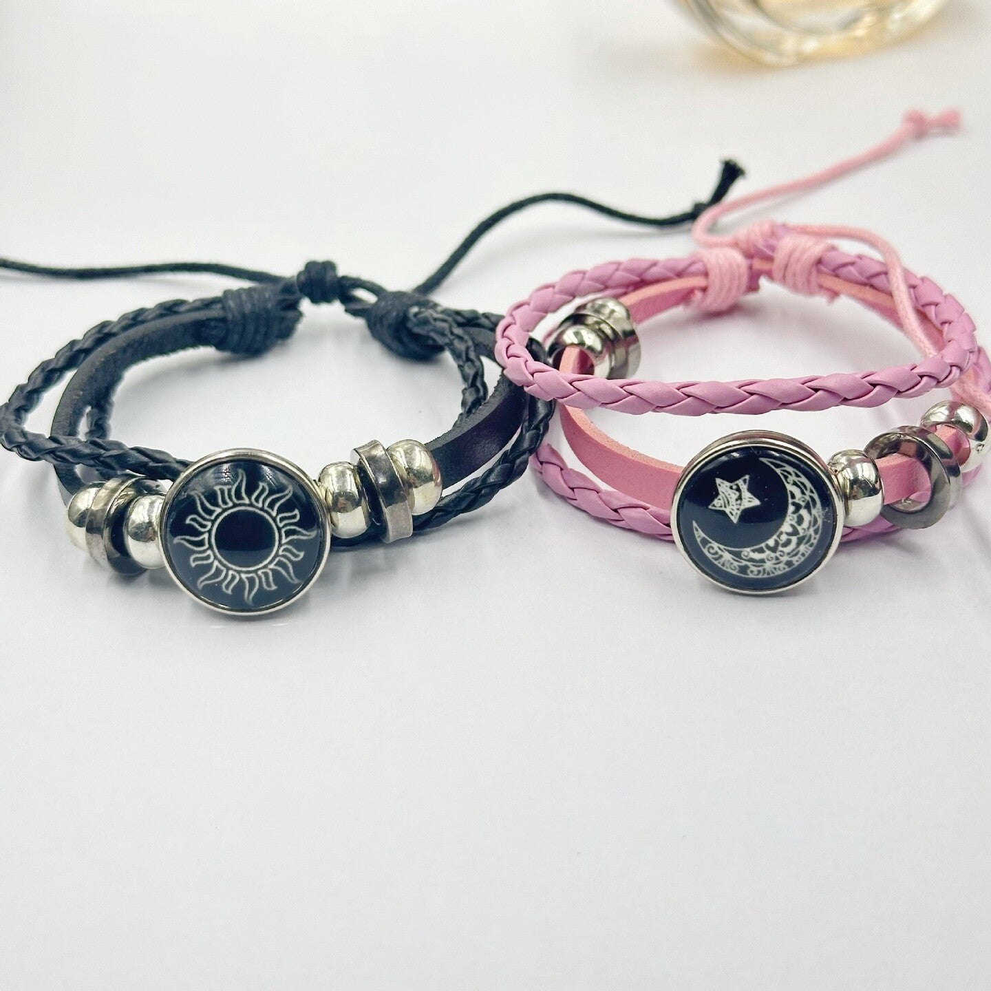 Pink braided cord bracelet with a moon and star charm and adjustable cord