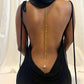 Gold back chain with crystal accents and a teardrop on an open back