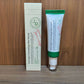 AXIS-Y Dark Spot Correcting Glow Serum carton beside its white and green tube on a wooden shelf
