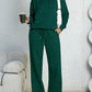 Dark green fleece hooded sweatshirt and wide-leg sweatpants set worn by a model