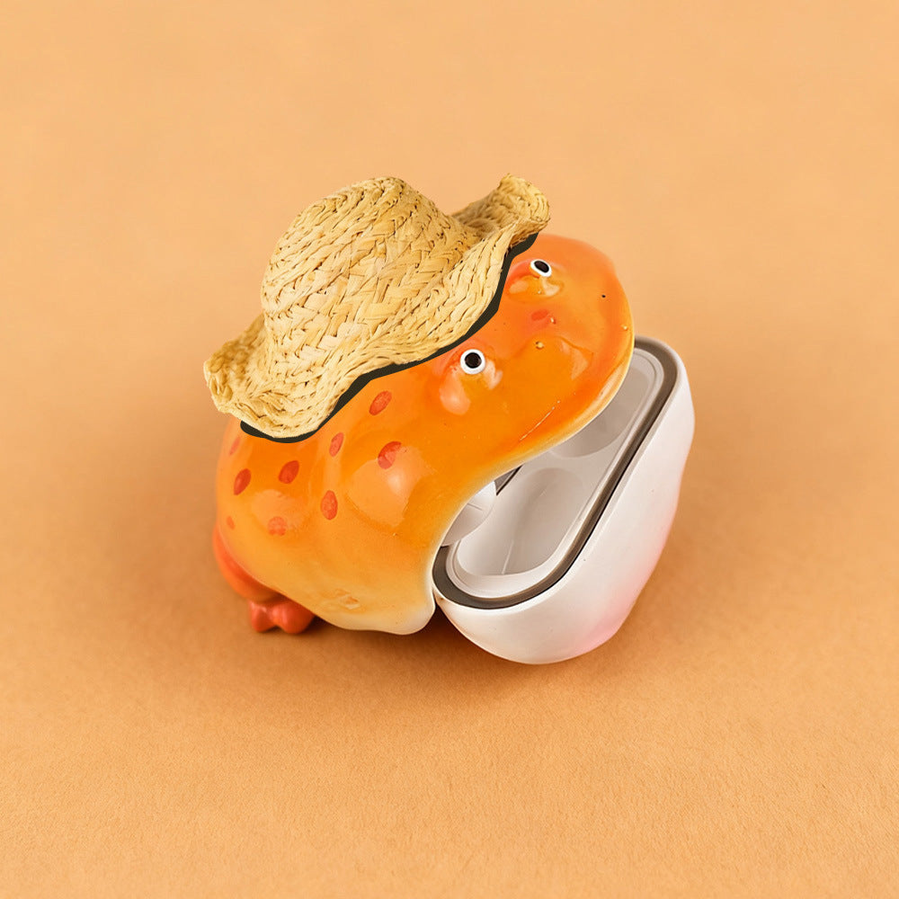 Orange frog case in a straw hat, head tipped back off the white lower shell