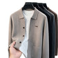 Taupe knit men's cardigan with turn-down collar and patch pocket on a hanger, white background